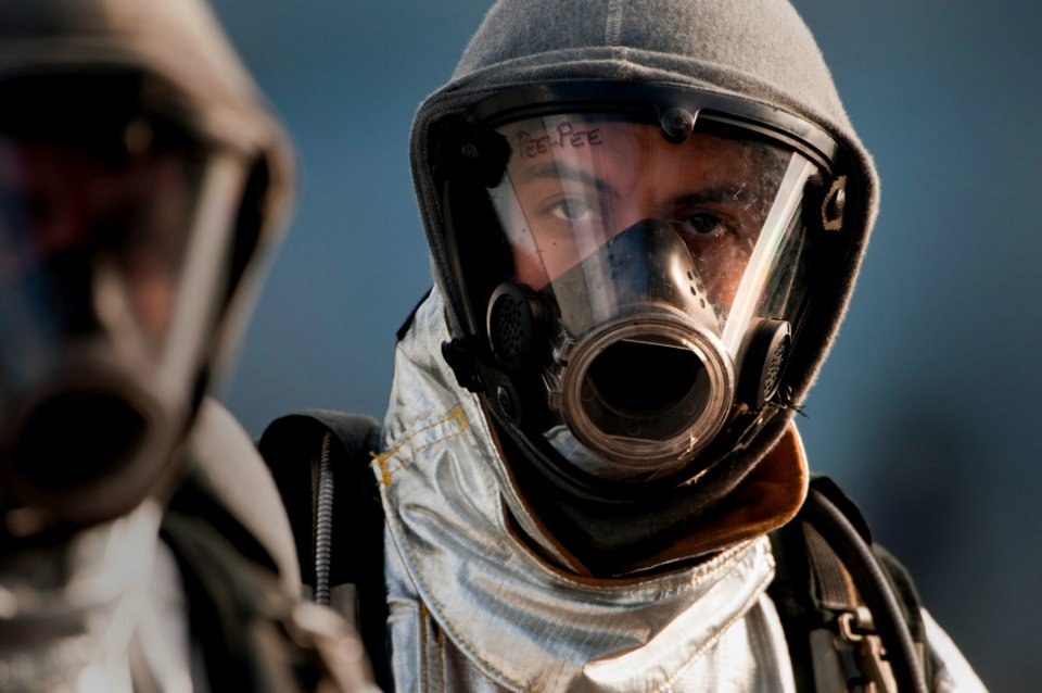 US Navy 091029-N-5319A-030 Aviation Boatswain's Mate (Handling) 3rd Class Olimpo Hurtabo waits to have his firefighting ensemble inspected on the flight deck of the amphibious assault ship USS Nassau (LHA 4)