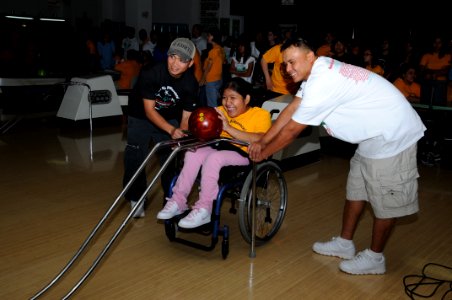US Navy 091031-N-1906L-005 Utilitiesman 3rd Class Jan Michael Imson, right, and Utilitiesman 2nd Class Jaypee DeGuzman, assigned to the U.S. Naval Facilities Engineering Command Marianas, assist Special Olympics Guam athletes a photo