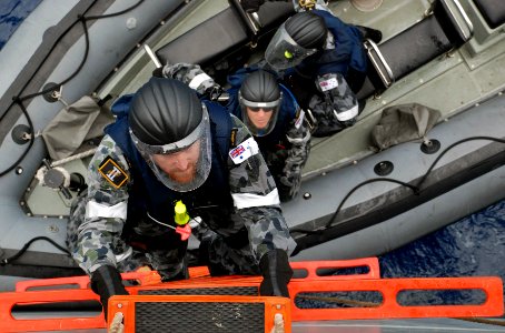 US Navy 091029-N-7095C-048 Members of an Australian boarding team disembark a rigid-hull inflatable boat and climb aboard the Military Sealift Command fleet replenishment oiler USNS Walter S. Diehl (T-AO 193) during a Deep Sabr