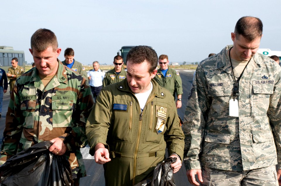 US Navy 091027-N-9552I-140 U.S. service members and members of the Italian Air Force 41st Stormo perform a foreign object debris walk-down on the flight-line at Naval Air Station Sigonella