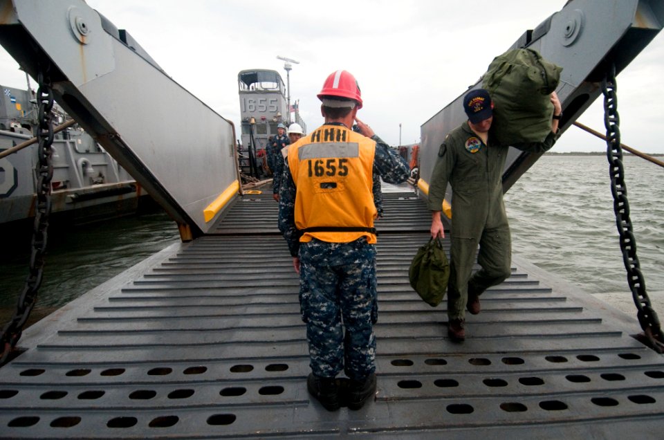 US Navy 091028-N-5319A-242 Boatswain's Mate 3rd Class Larry Haney, salutes an officer as he departs Landing Craft Unit 1655 (LCU 1655)