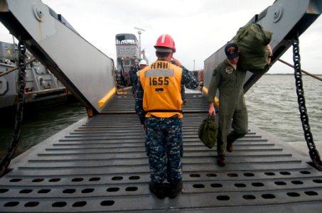 US Navy 091028-N-5319A-242 Boatswain's Mate 3rd Class Larry Haney, salutes an officer as he departs Landing Craft Unit 1655 (LCU 1655)