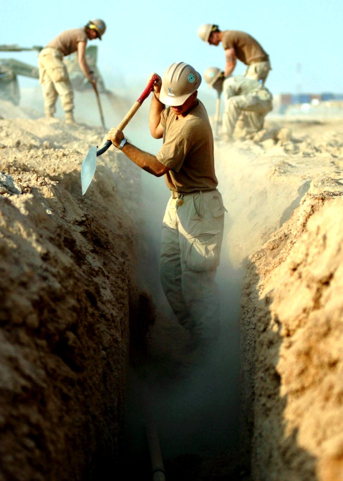US Navy 091029-N-4440L-162 Seabees assigned to Naval Mobile Construction Battalion (NMCB) 74 bury two kilometers of fiber optic cable for their new camp in the expansion area of Camp Leatherneck, Afghanistan