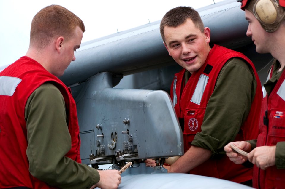 US Navy 091028-N-5319A-247 Marine air crewmen work on an AV-8 Harrier aboard the amphibious assault ship USS Nassau (LHA 4) during a Composite Unit Training Exercise (COMPTUEX)