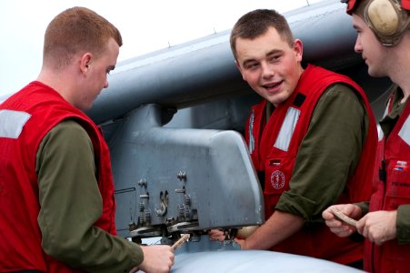 US Navy 091028-N-5319A-247 Marine air crewmen work on an AV-8 Harrier aboard the amphibious assault ship USS Nassau (LHA 4) during a Composite Unit Training Exercise (COMPTUEX)