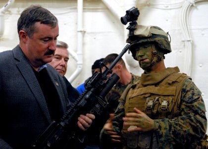 US Navy 091101-N-4971L-032 Lance Cpl. Travis Ervin, right, assigned to Special Purpose Marine Air-Ground Task Force 26, describes an M-16A2 assault rifle fitted with the M203 40 mm grenade launcher
