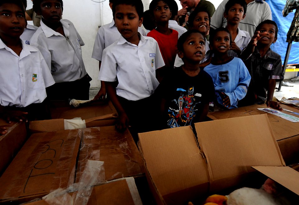 US Navy 091027-N-7280V-793 Sailors assigned to the amphibious command ship USS Blue Ridge (LCC 19) and Marines assigned to Fleet Anti-terrorism Security Team Pacific (FASTPAC) Company, 5th Platoon, bring toys to children