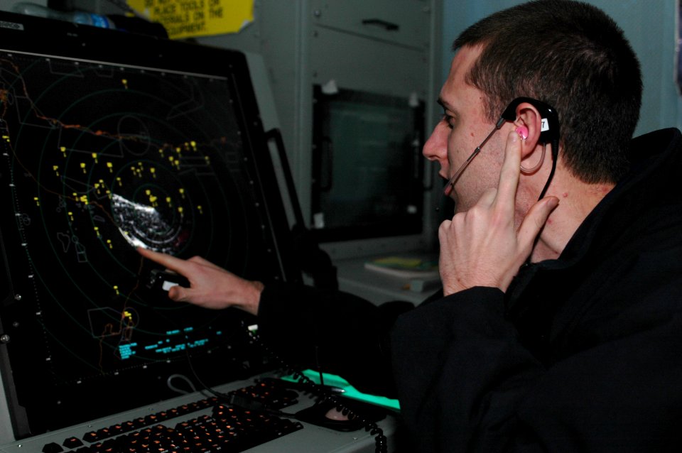 US Navy 091101-N-8960W-009 Air Traffic Controller 3rd Class Elliott Young, assigned to the aircraft carrier USS Nimitz (CVN 68), performs a traffic call to departing aircraft