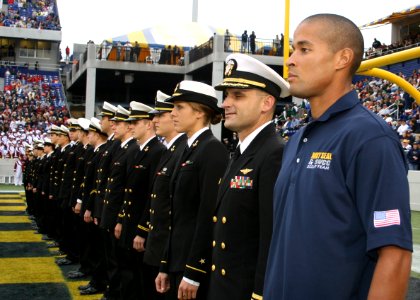 US Navy 091030-N-5366K-174 Special Warfare Operator 1st Class (SEAL) David Goggins stands at attention with members of the U.S. Naval Academy's triathlon team as they are recognized as Collegiate National Champions at the Navy photo