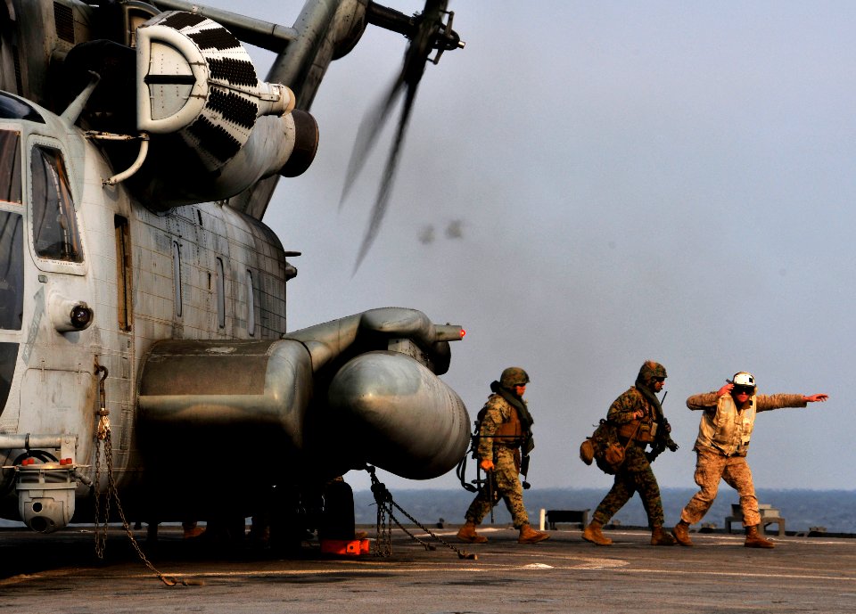 US Navy 091104-N-0807W-398 Marines disembark a Marine Corps CH-53E Sea Stallion helicopter