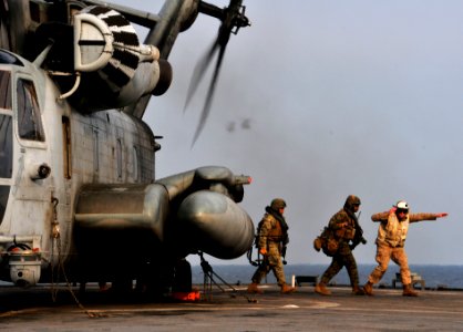 US Navy 091104-N-0807W-398 Marines disembark a Marine Corps CH-53E Sea Stallion helicopter