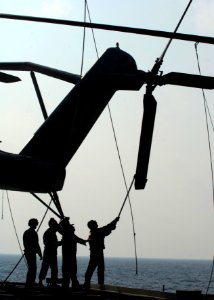 US Navy 091031-N-5538K-048 Marines assigned to the 31st Marine Expeditionary Unit (31st MEU) embarked aboard the amphibious transport dock ship USS Denver (LPD 9) tie down the rotors of a CH-53E Sea Stallion helicopter after fl photo