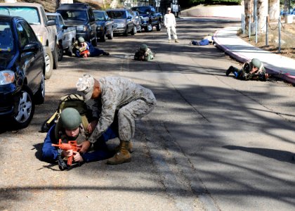 US Navy 091030-N-7032B-031 Hospital Corpsman 2nd Class Allan Antonio, front right, instructs Hospitalman Apprentice Christopher Gatpandan on the proper technique of 360 degree security during an in-coming drill at Naval Medical