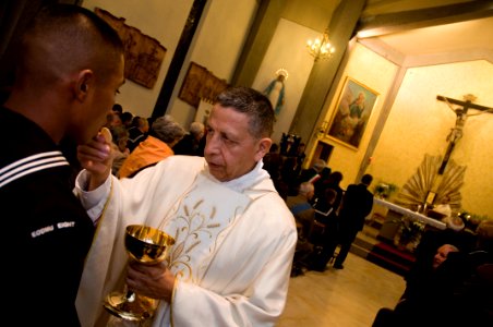 US Navy 091104-N-5821P-029 U.S. Navy Chaplain Cmdr. Alfonso Concha offers communion to Sailors of Naval Air Station Sigonella