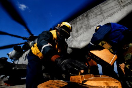 US Navy 091102-N-0807W-450 Boatswain's Mate 3rd Class Solomon Michel loads supplies and equipment onto a Marine Corps CH-53E Sea Stallion helicopter aboard the amphibious dock landing ship USS Harpers Ferry (LSD 49)
