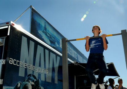 US Navy 091031-N-5208T-002 Visitors to the Wings Over Houston Air Show participate in pull-ups at the Accelerate Your Life display during a Houston Navy Week event