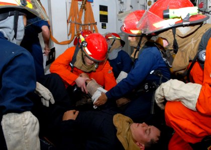 US Navy 091031-N-6692A-014 A medical team aboard the amphibious dock landing ship USS Tortuga (LSD 46) treats a simulated injury during a general quarters drill