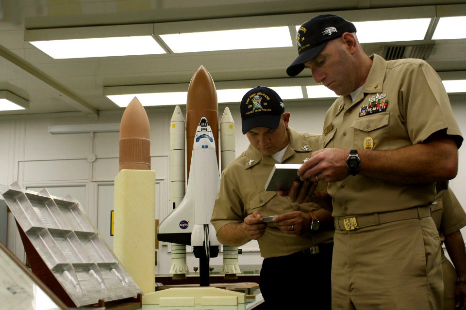 US Navy 091102-N-6736S-042 Command Master Chief Jeffery J. Kozlik and Electronics Technician 1st Class Tomas L. Davila examine new welding techniques developed by NASA during a tour of the Michoud Assembly Facility, a NASA faci