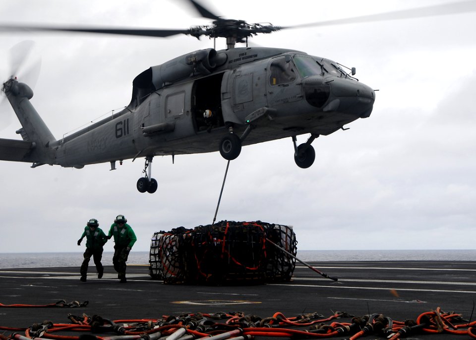 US Navy 091105-N-6233H-088 An SH-60F Sea Hawk helicopter assigned to the Chargers of Helicopter Anti-Submarine Squadron (HS) 14 lifts cargo from the aircraft carrier USS George Washington (CVN 73)