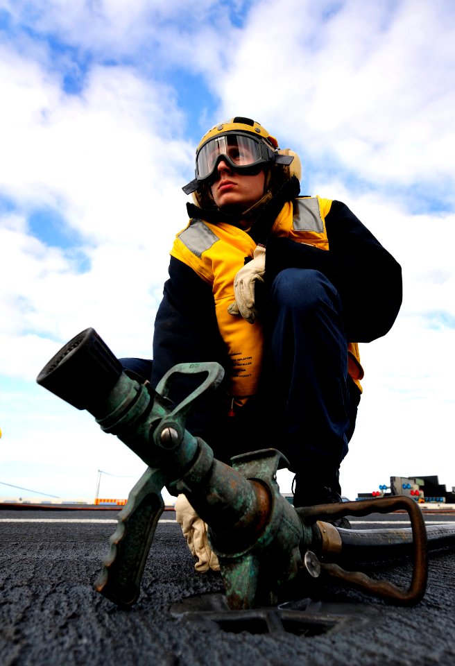 US Navy 091104-N-9928E-111 Airman Jared Blassett, from Springfield, Ill., mans a fire hose during drills aboard the aircraft carrier USS John C. Stennis (CVN 74)