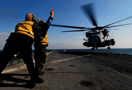US Navy 091102-N-0807W-467 Boatswain's Mate 3rd Class Kyle E. Eggering signals a Marine Corps CH-53E Sea Stallion helicopter aboard the amphibious dock landing ship USS Harpers Ferry (LSD 49) photo