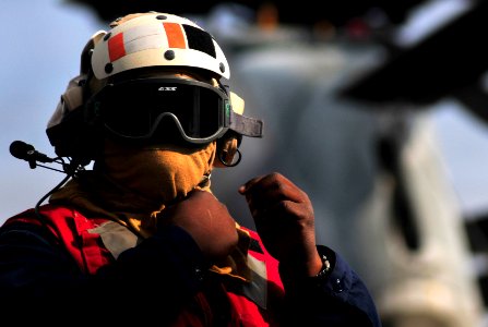 US Navy 091106-N-0807W-023 Damage Controlman 1st Class Gene A. Jefferson dons protective gear before flight operations aboard the amphibious dock landing ship USS Harpers Ferry (LSD 49)