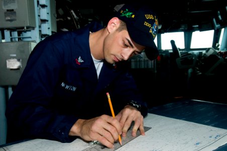 US Navy 091105-N-1251W-015 Quartermaster 2nd Class Cody Newton, from Jasper, Ga., plots distances on a chart aboard the guided-missile destroyer USS Lassen (DDG 82)