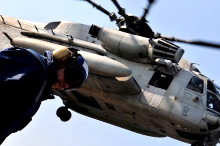 US Navy 091102-N-0807W-032 Seaman Craig R. Murphy stands by to chock and chain a Marine Corps CH-53E Sea Stallion helicopter during flight operations aboard the amphibious dock landing ship USS Harpers Ferry (LSD 49)