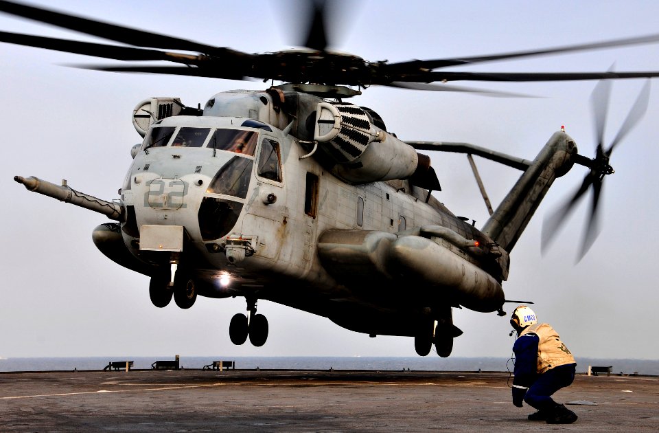 US Navy 091104-N-0807W-394 Senior Chief Boatswain's Mate Marvin Guinto observes a Marine Corps CH-53E Sea Stallion helicopter land aboard the amphibious dock landing ship USS Harpers Ferry (LSD 49)