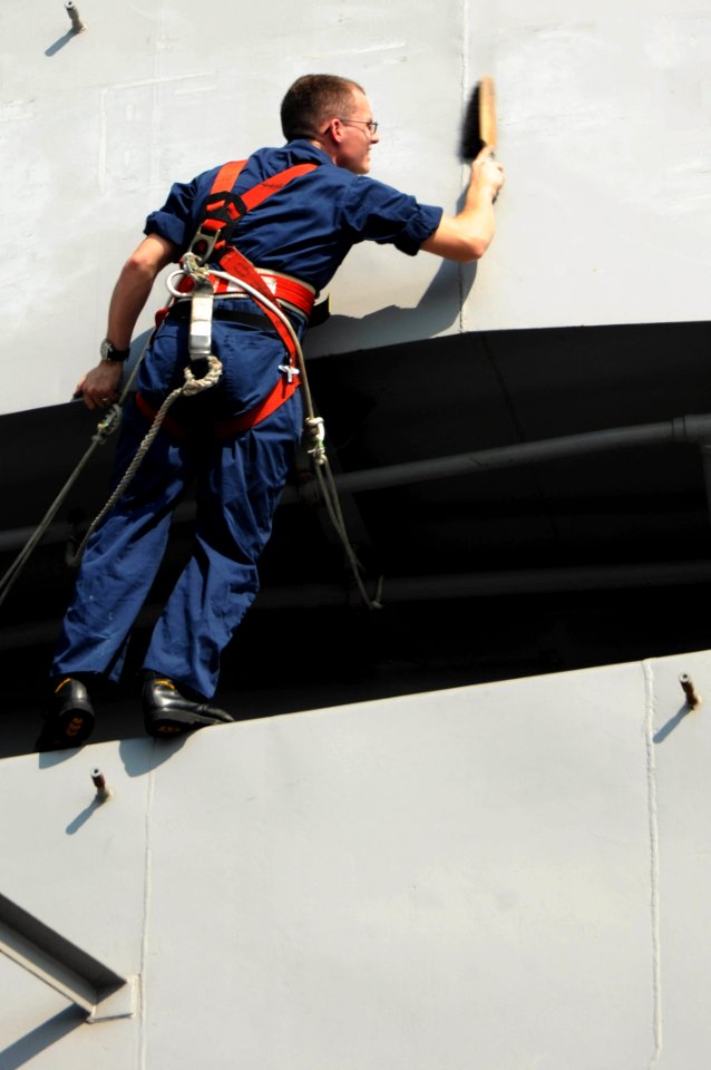US Navy 091104-N-3038W-055 Quartermaster 2nd Class Cameron Fletcher sands the bridge wing of the aircraft carrier USS Nimitz (CVN 68)