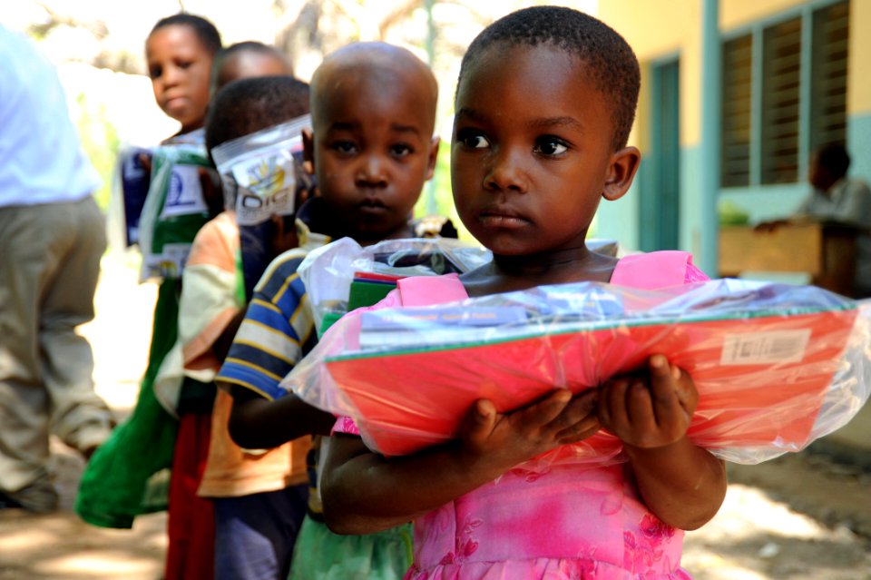 US Navy 091102-N-2420K-127 A child holds a packet of school supplies at the Tongoni Primary School in Tanga, Tanzania