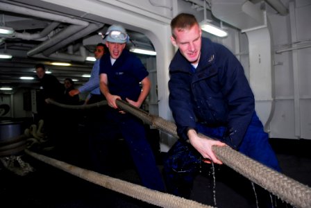 US Navy 091106-N-2475A-003 Boatswain's Mate 3rd Class Richard Gunsel, right, from Fresno, Calif., and Seaman William Dodd, from Burlington, Wash., heave a mooring line in the forecastle aboard the Nimitz-class aircraft carrier