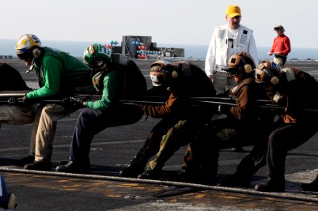 US Navy 091104-N-3038W-152 ailors aboard the aircraft carrier USS Nimitz (CVN 68) rig the aircraft barricade during flight deck drills photo
