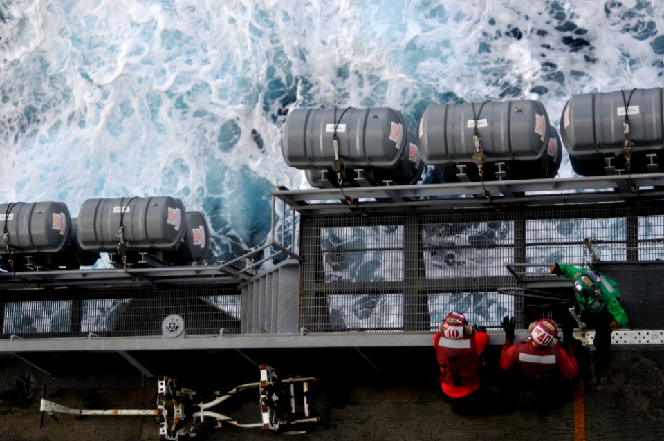 US Navy 091104-N-3595W-081 Sailors relax during a break between flight operations on the flight deck of the aircraft carrier USS Dwight D. Eisenhower (CVN 69)