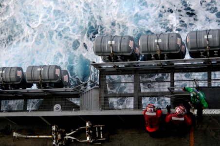US Navy 091104-N-3595W-081 Sailors relax during a break between flight operations on the flight deck of the aircraft carrier USS Dwight D. Eisenhower (CVN 69)