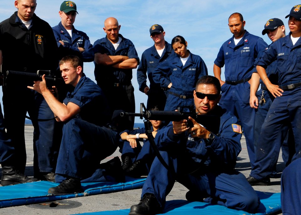 US Navy 091107-N-6692A-028 Gunner's Mate 2nd Class Andres Fernandez and Gunner's Mate Seaman Thomas Chapman demonstrate proper handling of M-16 rifles during small arms qualifications