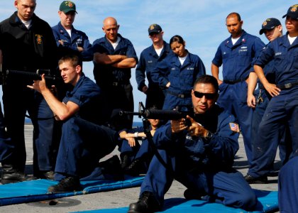 US Navy 091107-N-6692A-028 Gunner's Mate 2nd Class Andres Fernandez and Gunner's Mate Seaman Thomas Chapman demonstrate proper handling of M-16 rifles during small arms qualifications