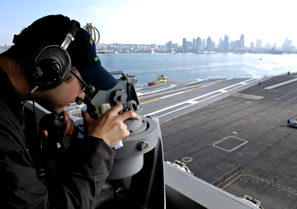 US Navy 091105-N-4954I-011 Quartermaster 2nd Class Chance Gorden, from Baker City, Ore., takes bearings with a telescopic alidade on the signal bridge aboard the Nimitz-class aircraft carrier USS John C. Stennis (CVN 74)