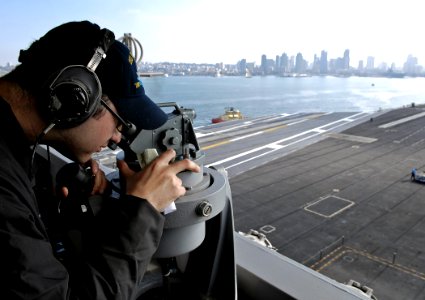 US Navy 091105-N-4954I-011 Quartermaster 2nd Class Chance Gorden, from Baker City, Ore., takes bearings with a telescopic alidade on the signal bridge aboard the Nimitz-class aircraft carrier USS John C. Stennis (CVN 74)