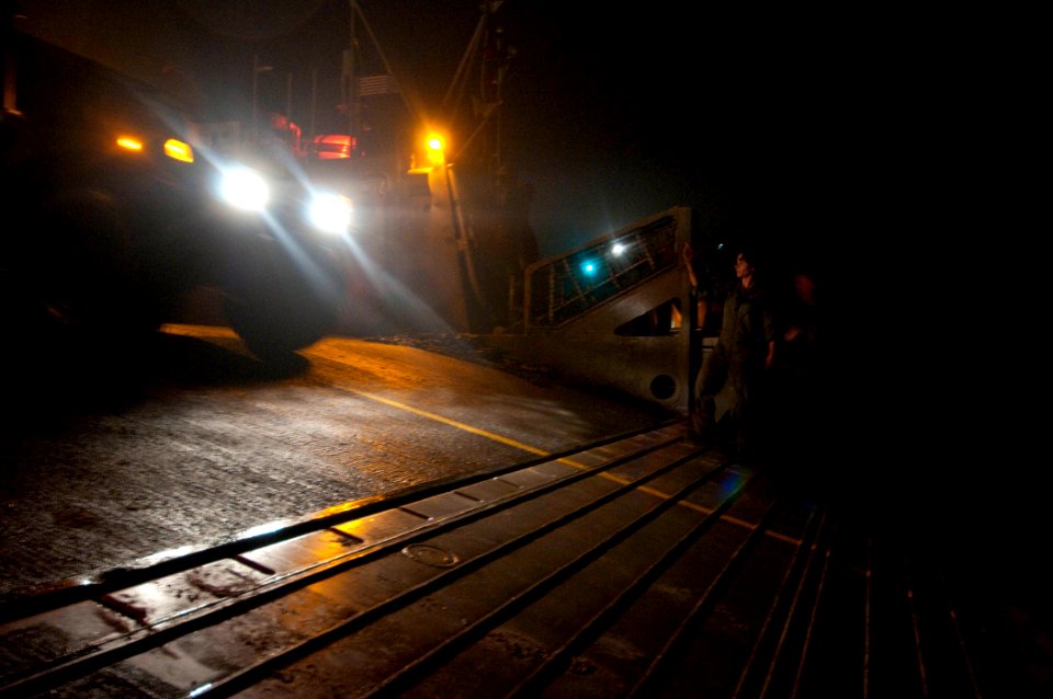 US Navy 091105-N-5319A-059 Boatswain's Mate 2nd class Gena Bartek, assigned to Assault Craft Unit (ACU) 4, directs Marines from the 24th Marine Expeditionary Unit (24th MEU) as they disembark from a landing craft air cushion (L