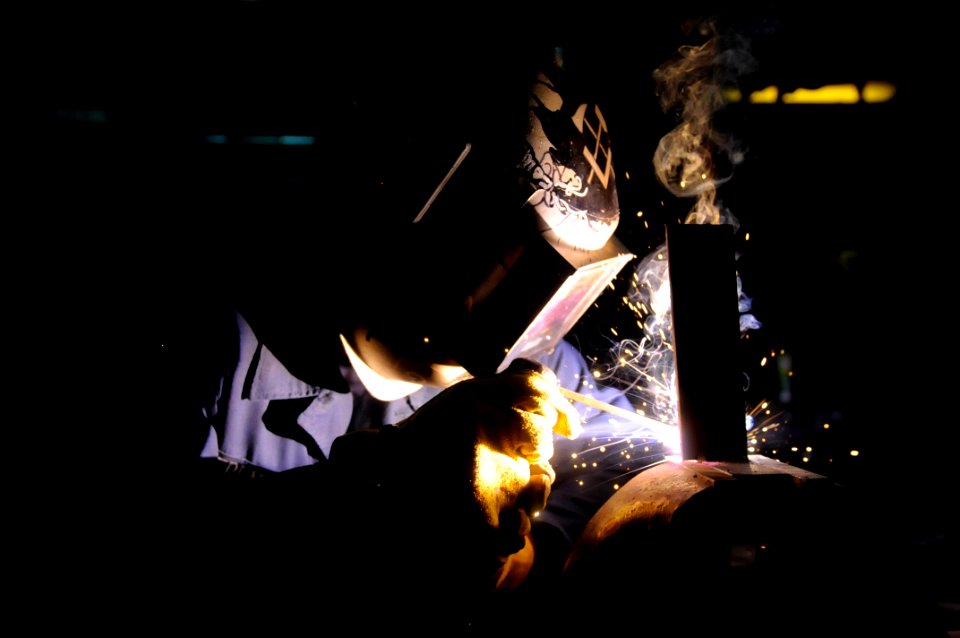 US Navy 091105-N-7478G-054 Hull Maintenance Technician Fireman Cole French welds a T-shaped bracket for a bulkhead
