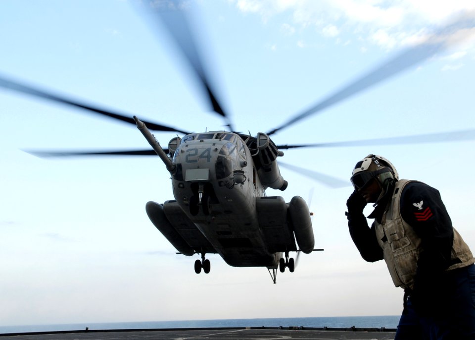 US Navy 091105-N-6692A-012 Boatswain's Mate 1st Class David Brown observes as a Marine Corps CH-53 Sea Stallion helicopter lands