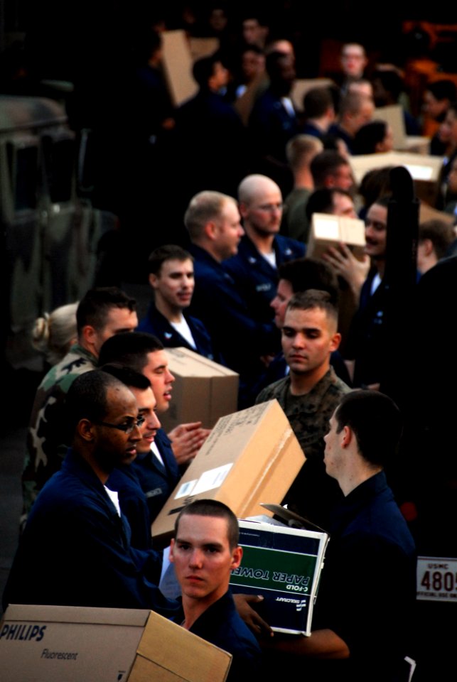US Navy 091106-N-0807W-862 Sailors and Marines aboard the amphibious dock landing ship USS Harpers Ferry (LSD 49) move supplies during a vertical replenishment