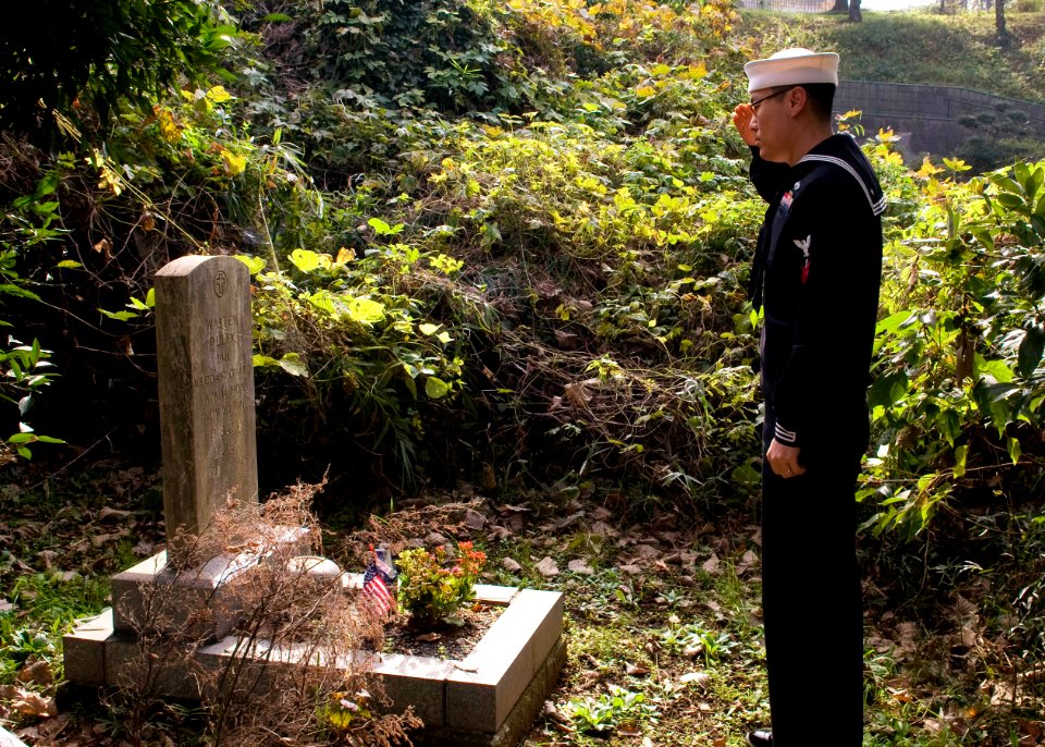 US Navy 091107-N-8534H-002 Logistics Specialist 2nd Class Yu He, from Houston, salutes the grave of U.S. Coast Guard Boatswain's Mate 1st Class Walter Dulek