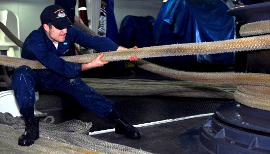 US Navy 091106-N-2475A-007 Seaman Sean Flaherty, from Philadelphia, heaves a mooring line in the forecastle aboard the Nimitz-class aircraft carrier USS John C. Stennis (CVN 74)