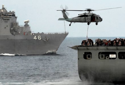 US Navy 091106-N-0807W-520 An MH-60S Sea Hawk helicopter from the Island Knights of Helicopter Sea Combat Squadron (HSC) 25 lifts supplies from the Military Sealift Command dry cargo-ammunition ship USNS Alan Shepard (T-AKE 3)