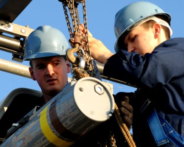 US Navy 091106-N-0120A-042 Fire Controlman 2nd Class Stephen Woodall, right, and Fire Controlman 3rd Class Kyle Schropp, load a RIM-116 Rolling Airframe Missile (RAM) into the missile launcher aboard