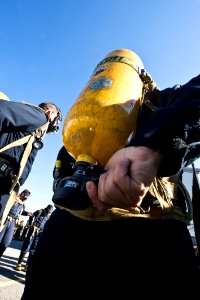 US Navy 091106-N-2953W-021 A Sailor activates his self-contained breathing apparatus during the Basic Shipboard Firefighting Course at Farrier Firefighting School photo