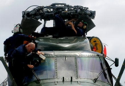 US Navy 091105-N-7280V-390 Sailors conduct maintenance on an SH-60F Sea Hawk helicopter