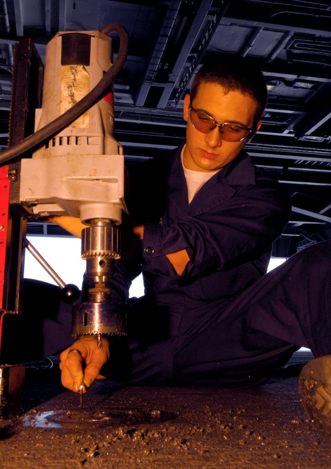 US Navy 091107-N-8913A-067 Machinery Repairman Fireman Chris Wiserma removes a hydrolic fuel tank cap aboard the aircraft carrier USS Harry S. Truman (CVN 75)
